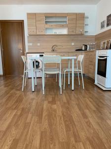 a kitchen with a table and chairs in a kitchen at Sunny Home in Sandanski +8 photos