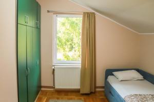 a bedroom with a bed and a window at Yellow house in Novi Sad