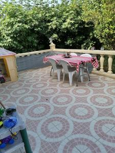 a table and chairs sitting on a tiled patio at Maison proche circuit 24h du mans in Spay