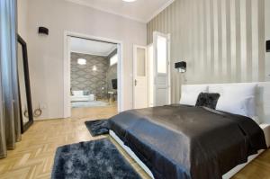 1 dormitorio con 1 cama grande y alfombras azules en Premium Apartment by Hi5 - Lendvay Palace en Budapest