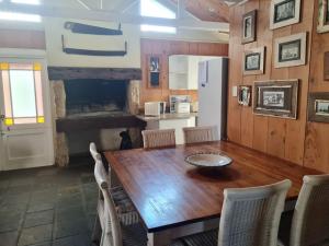 a dining room with a wooden table and chairs at Point Village Accommodation -Linky's House in Mossel Bay
