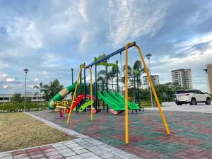 a playground with a slide in a park at Luxury Condo in Clark Pampanga beside Hilton Hotel and Casino in Angeles
