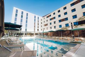 a swimming pool in front of a hotel at ibis Budget La Rochelle Centre in La Rochelle