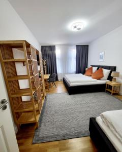 a bedroom with a bed and a book shelf at Marcel Apartments Leipzig in Leipzig
