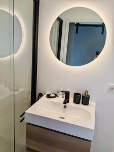 a bathroom with a sink and a mirror at Surla luxury sailing Houseboat Splendid at Marina Monnickendam in Monnickendam