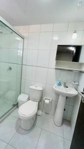 uma casa de banho branca com um WC e um lavatório em Hermoso y cómodo monoambiente em Cochabamba