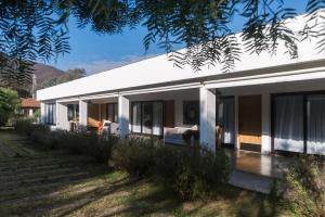 a white house with glass doors and windows at Haus Apart Hotel in Salta