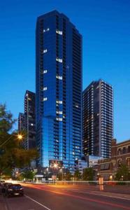 a city skyline with tall skyscrapers at night at Modern 3 Bedroom 2 Bathroom Apt Southbank in Melbourne