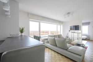 a living room with a couch and a table at Nice studio with big terrace in Brussels