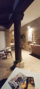 a living room with a pillar and a table at DIMORA AL SARACENO in Ferrara