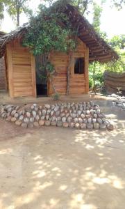 a house with a pile of rocks in front of it at seven peacock Home Residence in Tangalle