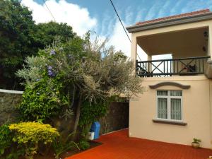 a house with a tree in front of it at Alcazaba Villa in Trou aux Biches