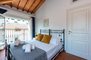 a bedroom with a bed and a large window at Palazzo Ghibellina by Rental in Florence in Florence