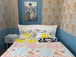 a bedroom with a bed and a picture on the wall at hotel castle in Kutaisi
