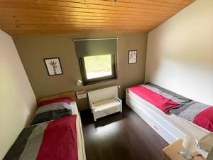 a bedroom with two beds and a window in it at Sauerländer Henne-Lütt in Meschede