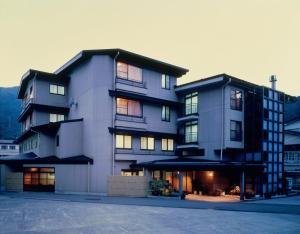 a large apartment building with a lot of windows at Hiratakan in Takayama