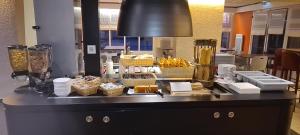 een buffet met manden eten op een aanrecht bij Kyriad Direct Nancy Sud -Vandoeuvre - Rénové in Vandoeuvre-lès-Nancy