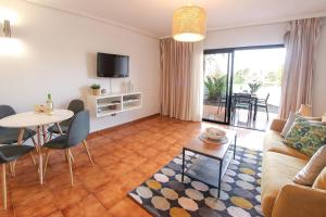 a living room with a couch and a table at Paradise Gardens - Golf del Sur in San Miguel de Abona