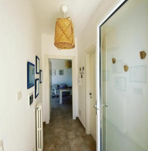 a hallway with a door leading to a dining room at RESIDENCE IL GIARDINO DI DONNA LEDA in Castro di Lecce