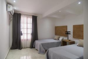 Ένα ή περισσότερα κρεβάτια σε δωμάτιο στο Haus Apart Hotel