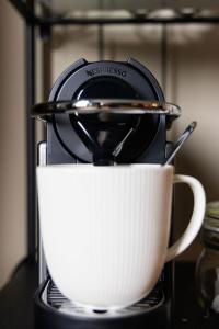 a coffee pot sitting on top of a coffee maker at Sleep at 55 in Tarporley