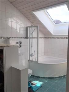 a bathroom with a shower and a tub and a sink at Ferienwohnung Kunze in Prien am Chiemsee