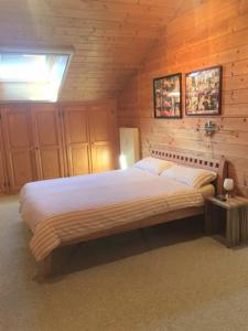a bedroom with a large bed in a wooden room at Ferienwohnung Kunze in Prien am Chiemsee