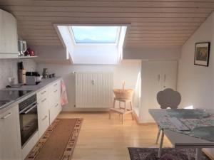 a kitchen with a skylight in the ceiling of a room at Ferienwohnung Kunze in Prien am Chiemsee