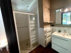 a small bathroom with a sink and a shower at La Liberté, Loft de 90 m2 rénové en centre-ville avec terrasse amenagee in Cambrai