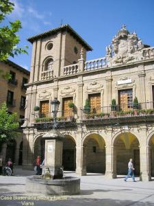 a man walking in front of a large building at Ven y desconecta!! in Viana