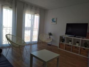 a living room with two chairs and a flat screen tv at Ven y desconecta!! in Viana
