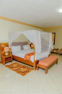 a bedroom with a bed with a canopy at Select Boutique Hotel Kigali in Kigali
