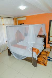 a bed with a canopy in a room at Select Boutique Hotel Kigali in Kigali