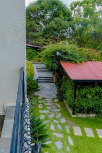 a walkway next to a building with a red roof at Select Boutique Hotel Kigali in Kigali
