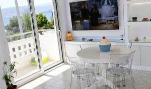 a white kitchen with a table with a cupcake on it at Efi's Luxury Suite in Agios Nikolaos