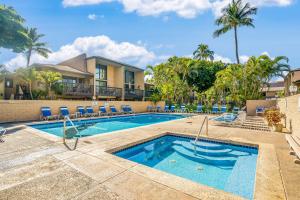 a swimming pool with chairs and a resort at Kihei Gardens Estates G104 in Kihei