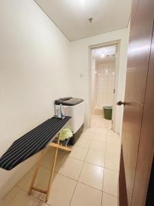a bathroom with a black and white bench in a room at Super Cozy 2BR Apt with direct access to Mall in Jakarta