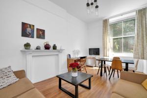 a living room with a couch and a table at Bedford Place Hostels in London