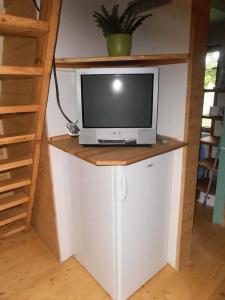 una TV seduta sopra un bancone in una stanza di Roztomilá a utulná chata Azzy na samotě v lese. a Valašské Klobouky