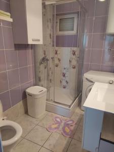 a bathroom with a shower and a toilet and a sink at The Look in Mali Lošinj +21 photos