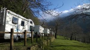 a couple of rvs parked next to a fence at Camping Camaldoli in Camaldoli