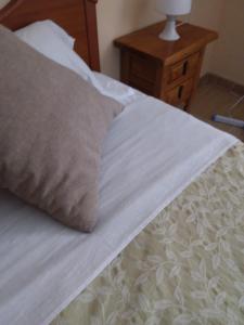 a close up of a bed with a pillow on it at Victoria Hospedaje in Alicante