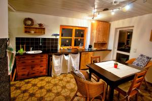 a kitchen with a table and a dining room at Fischerhaus in Burgthann