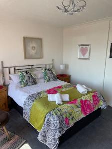 a bedroom with a large bed in a room at "The Celebration" Balcony Seafront Apartment in Eastbourne +23 photos