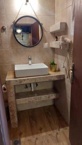 a bathroom with a sink and a mirror at Arxontiko Agonari in Metamorfosi +76 photos