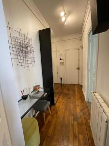 a room with a table and chairs in a room at We Loft in Paris