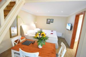 a room with a table with a laptop and flowers on it at Marcel Apartments Leipzig in Leipzig