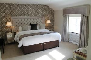 a bedroom with a large bed and a window at Spinners on Castle Street in Birr