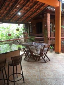 a patio with a table and chairs on a patio at Apartamento Exclusivo in Campo Grande