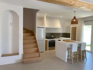 a kitchen with a staircase and a table in a kitchen at Chez Georges - Maison 1 - Les Gîtes du Verdon in Esparron-de-Verdon
